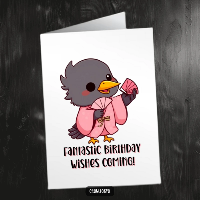 Funny Free Printable Birthday Card: Playful crow in a pink kimono balances a tiny fan on its beak, a cute DIY gift.