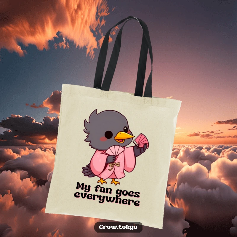 Funny tote bag depicting a playful crow in a pink kimono, balancing a tiny fan on its beak with skill.